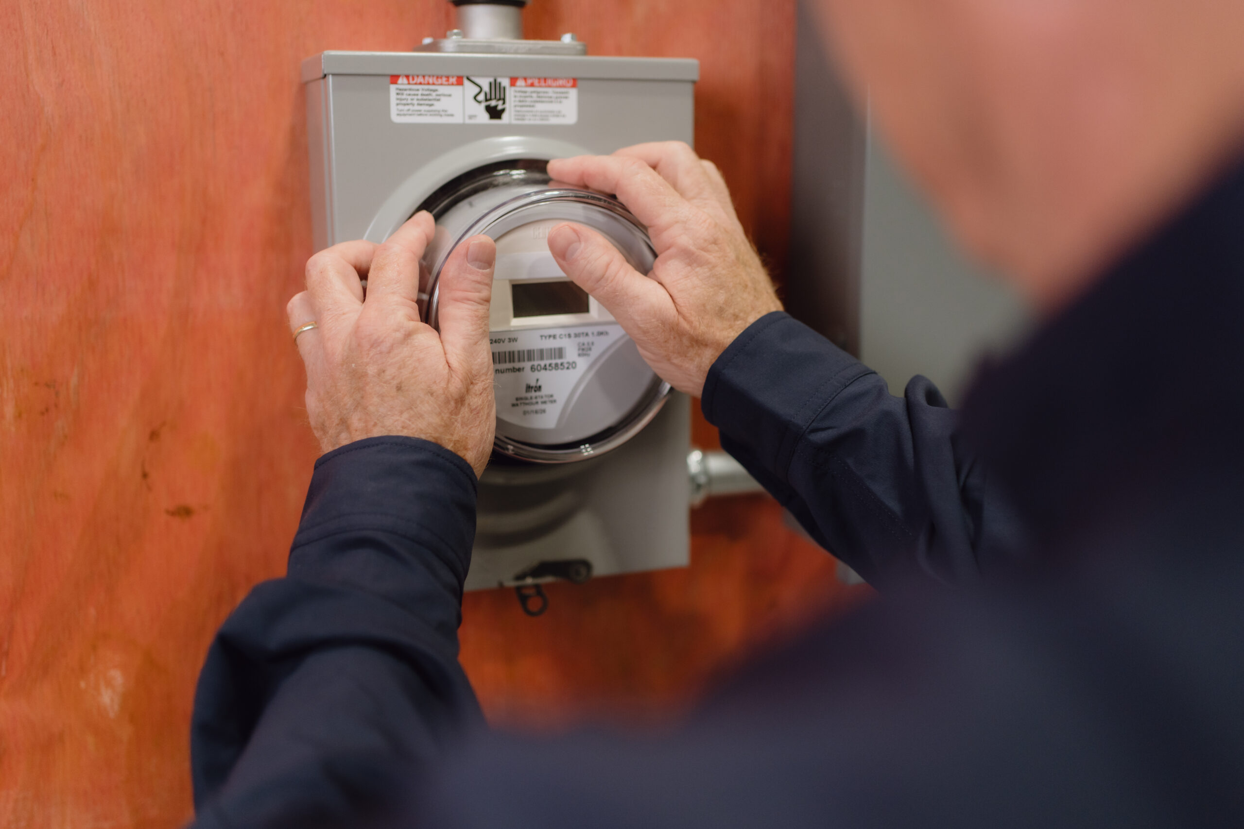 Student installing electrical meter in San Antonio lab
