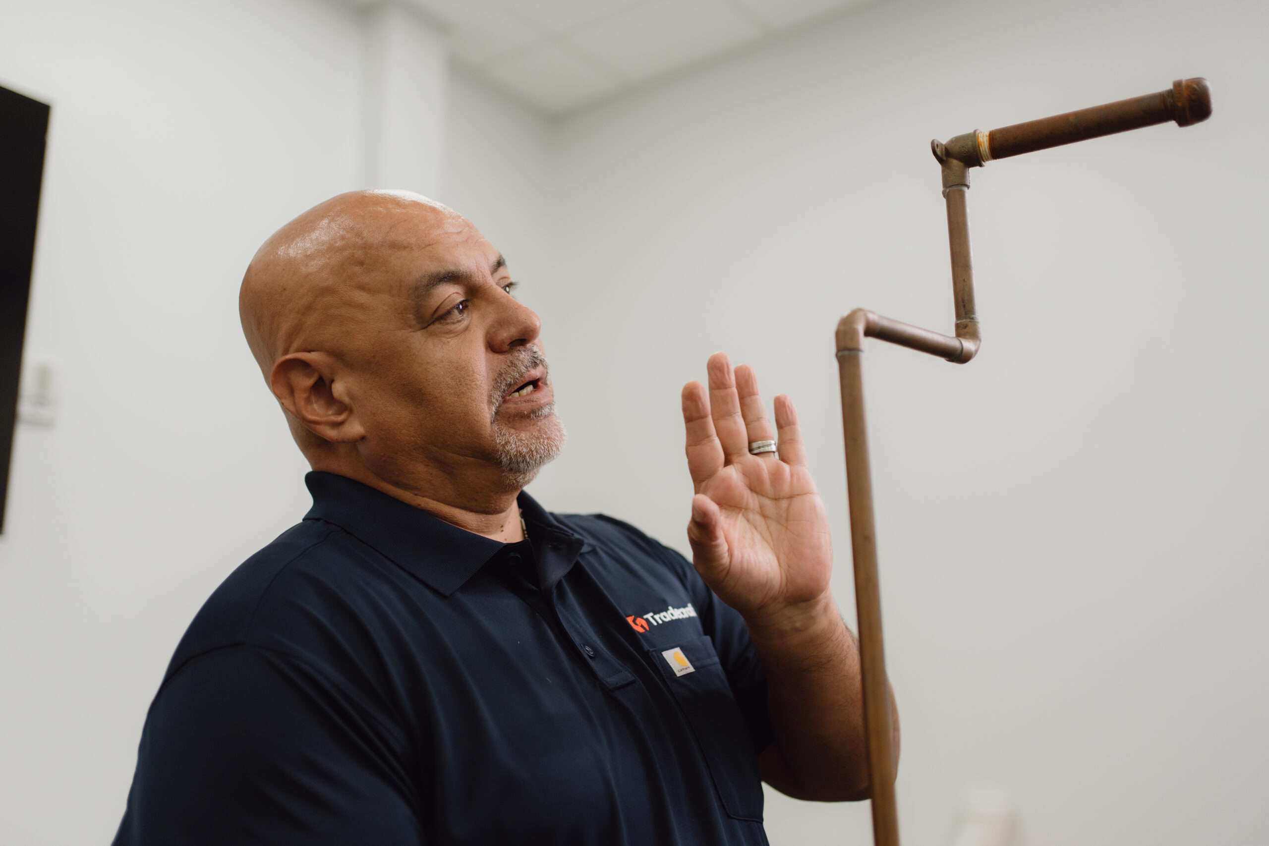 Plumbing instructor demonstrating techniques to small class