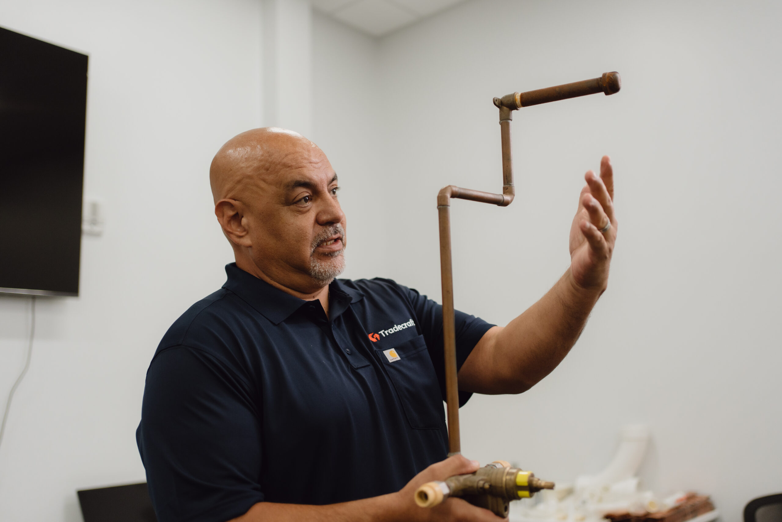 Tradecraft instructor demonstrating plumbing techniques