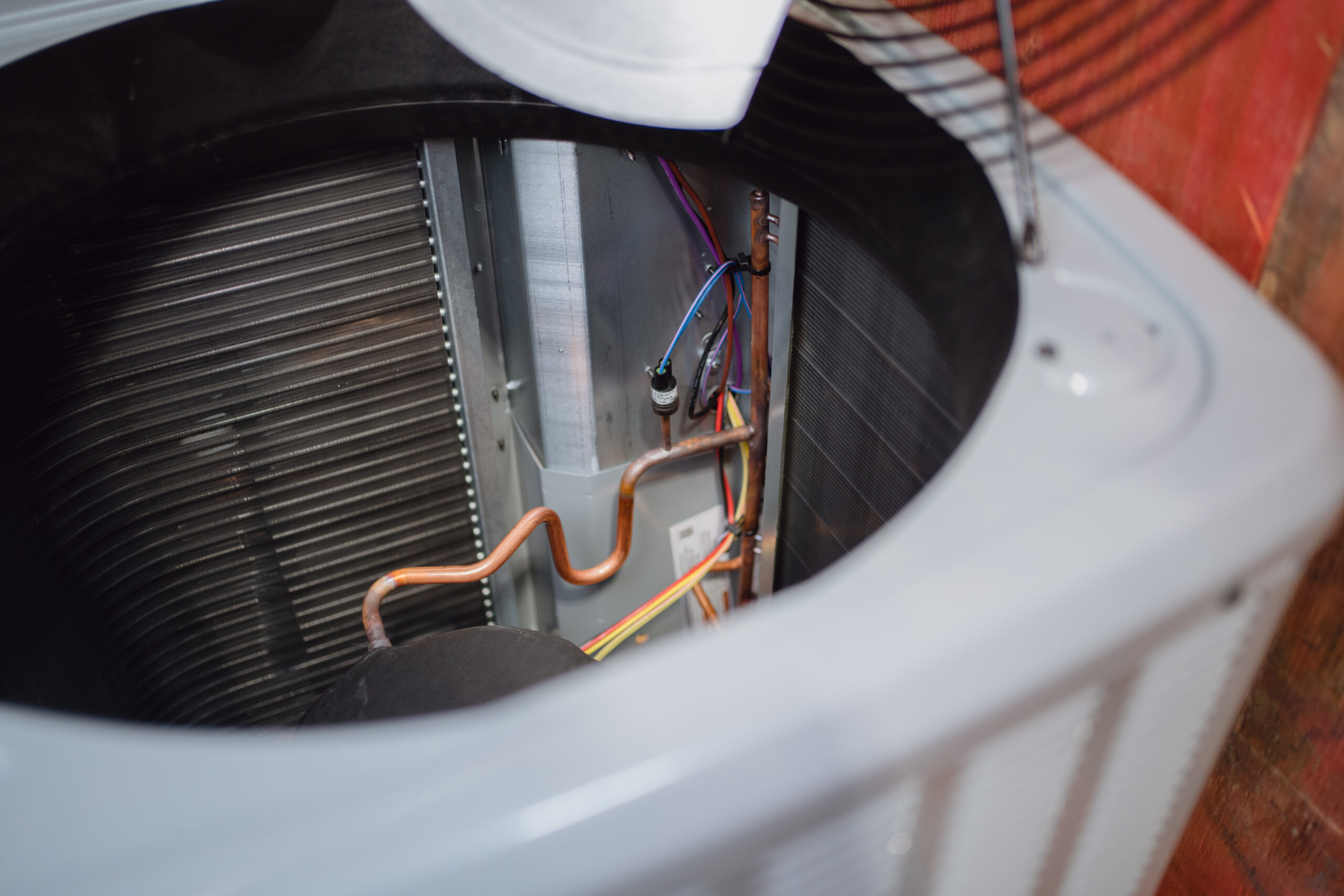 Inside view of an HVAC condensing unit and copper piping in the San Antonio lab