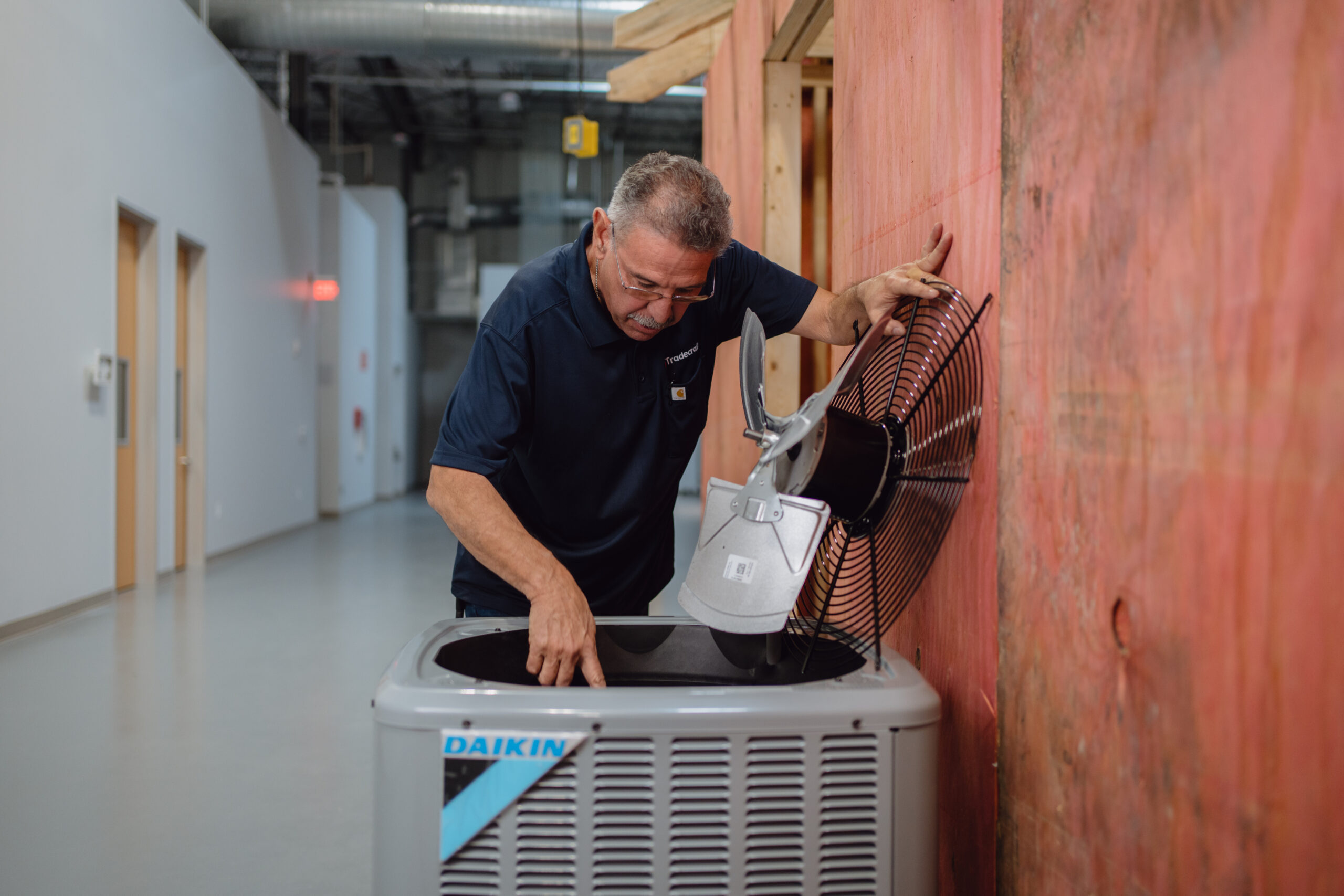 HVAC technician working on rooftop unit