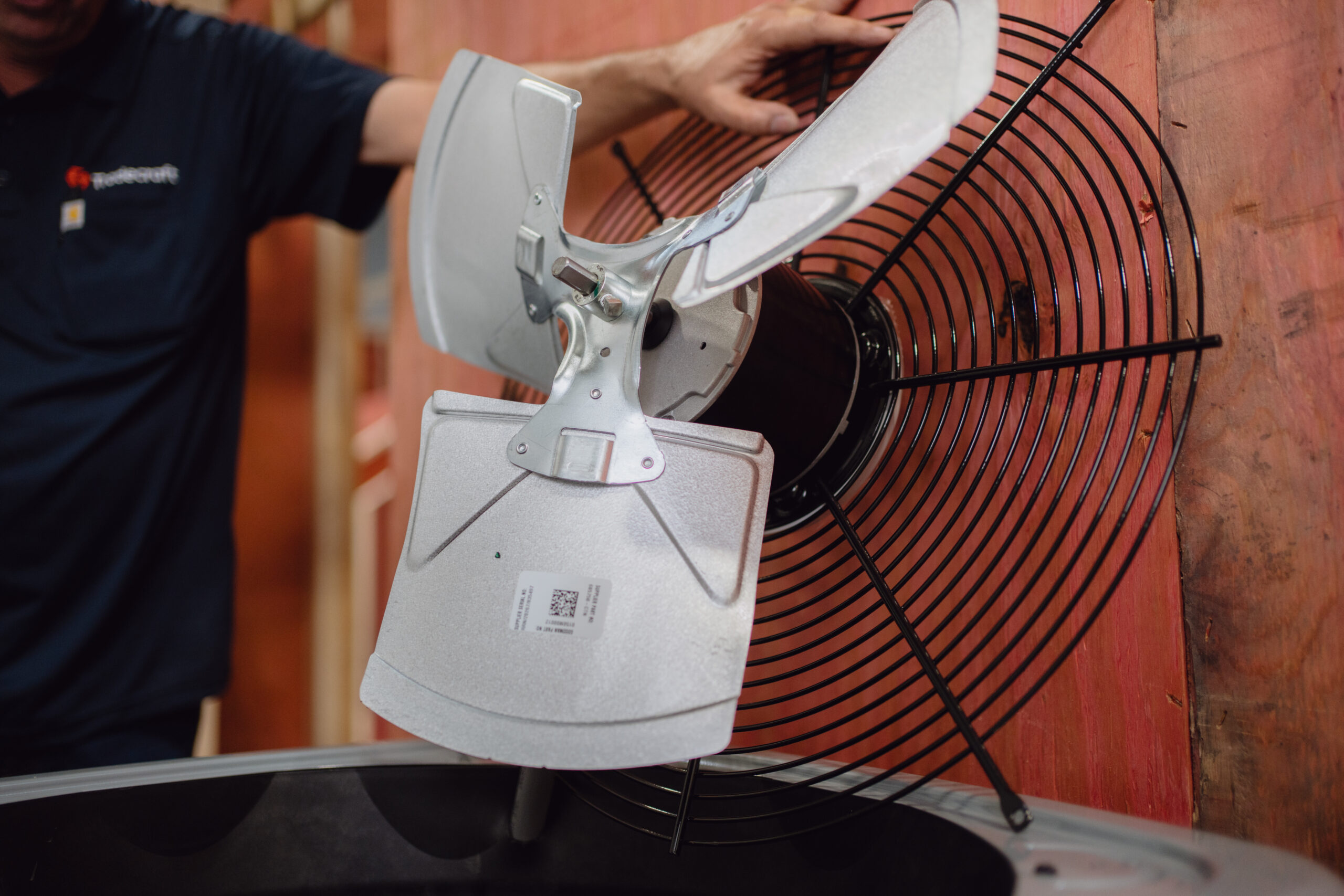 HVAC student opening and servicing a condensing unit