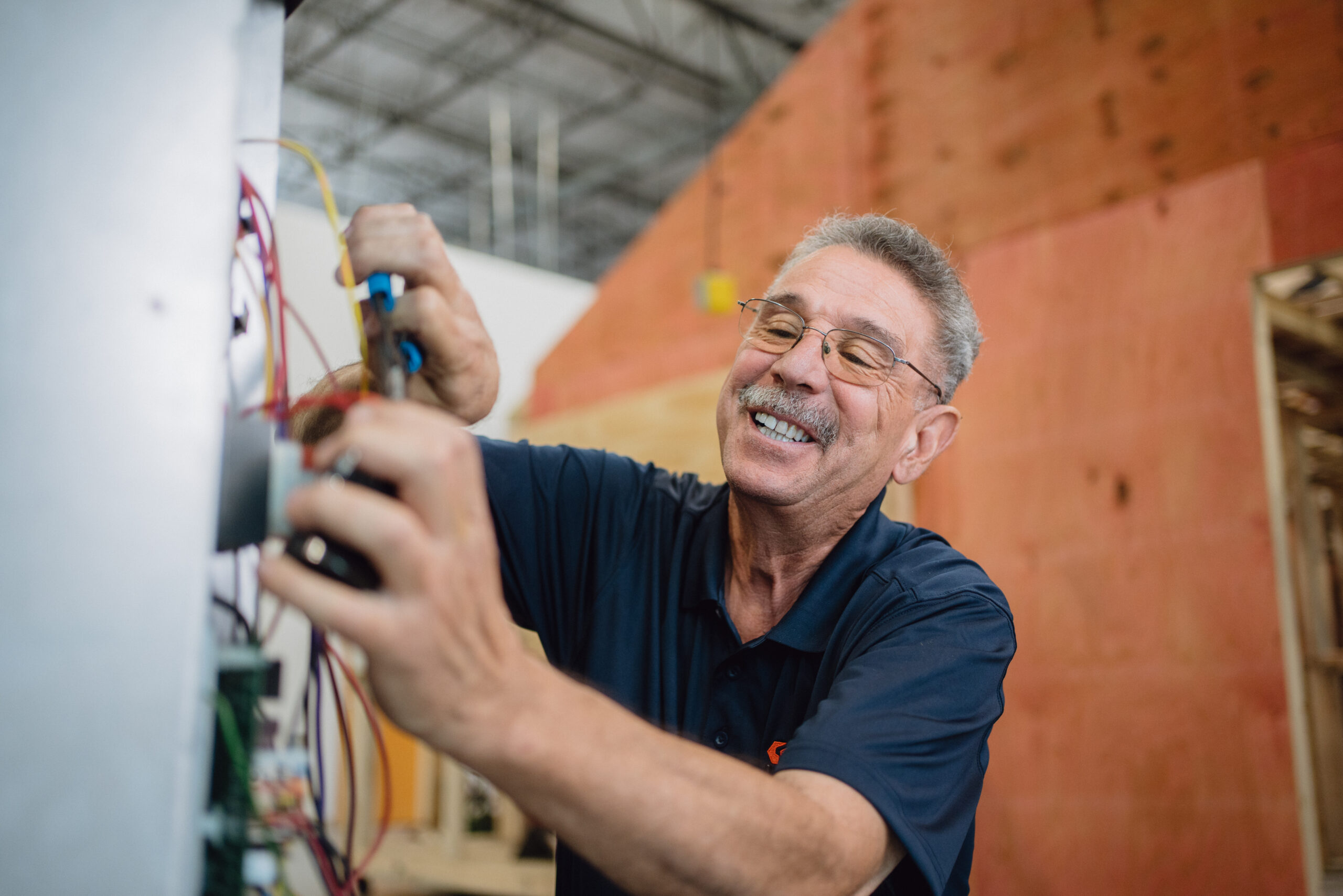 Instructor working on wiring panel in Tradecraft HVAC lab