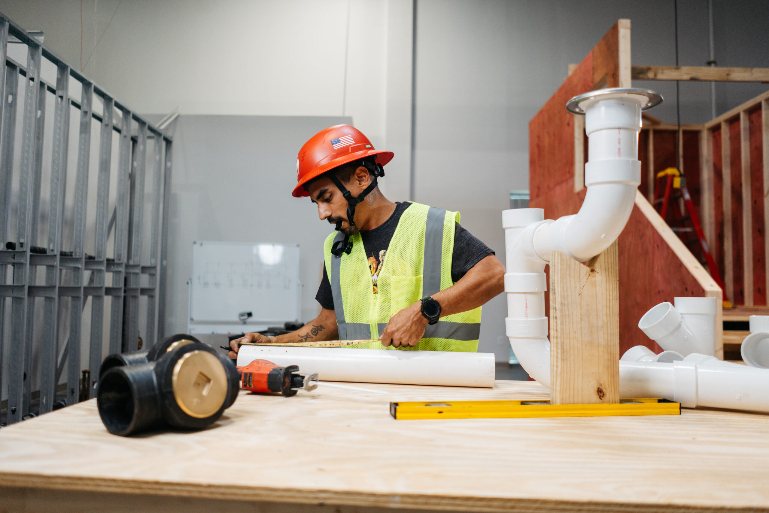 Tradecraft students practicing electrical and plumbing skills in the San Antonio lab