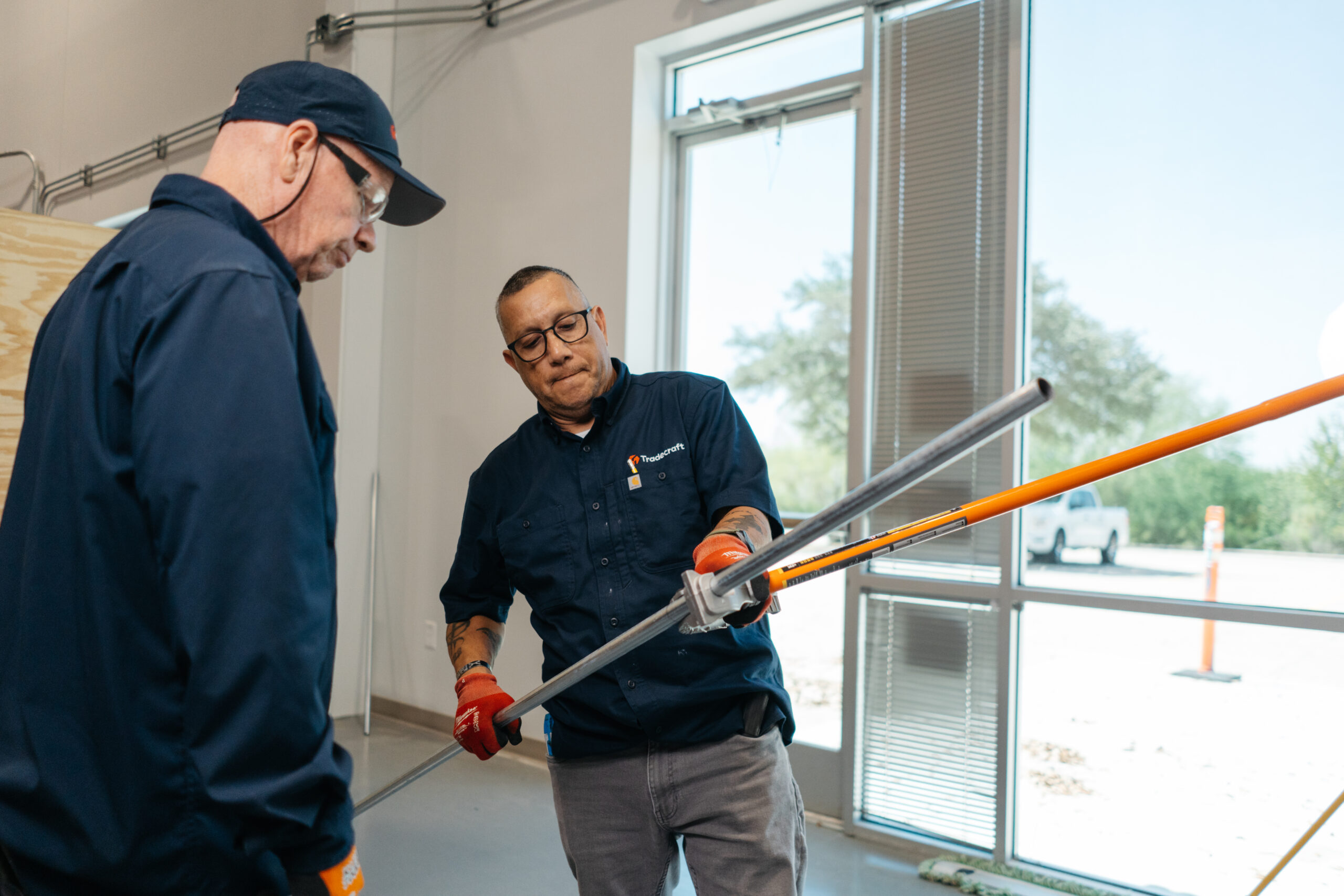 Tradecraft students training on electrical and plumbing systems in the San Antonio lab